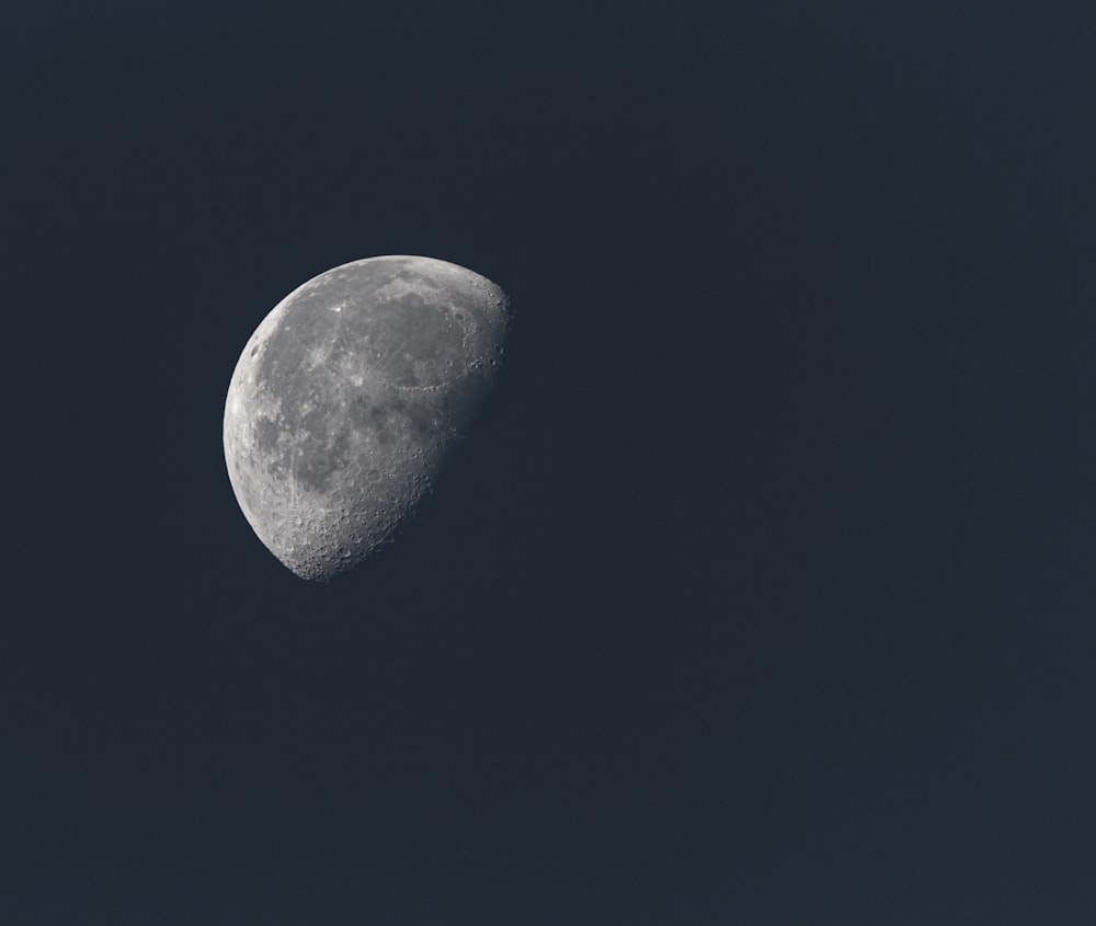 a half moon in a dark blue sky