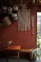 Artisan’s workspace with macramé cords and natural stones bathed in warm afternoon light.