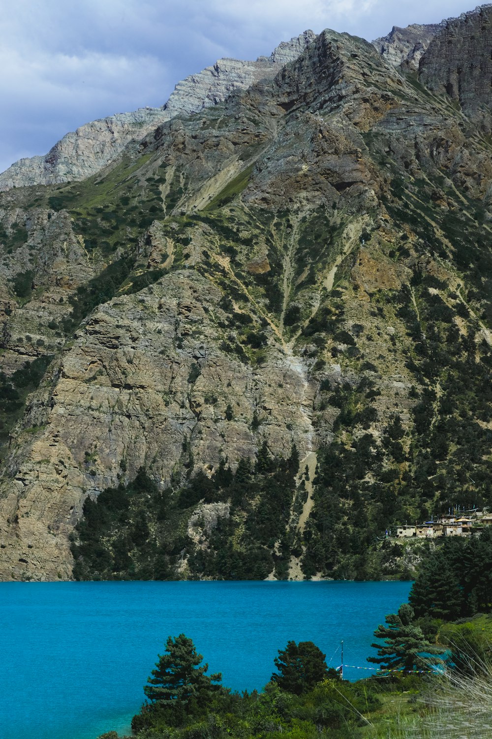 a large mountain with a body of water in front of it