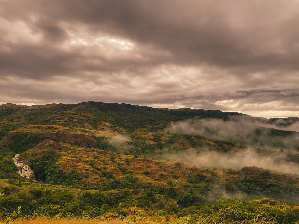 a scenic view of a mountain range with clouds in the sky