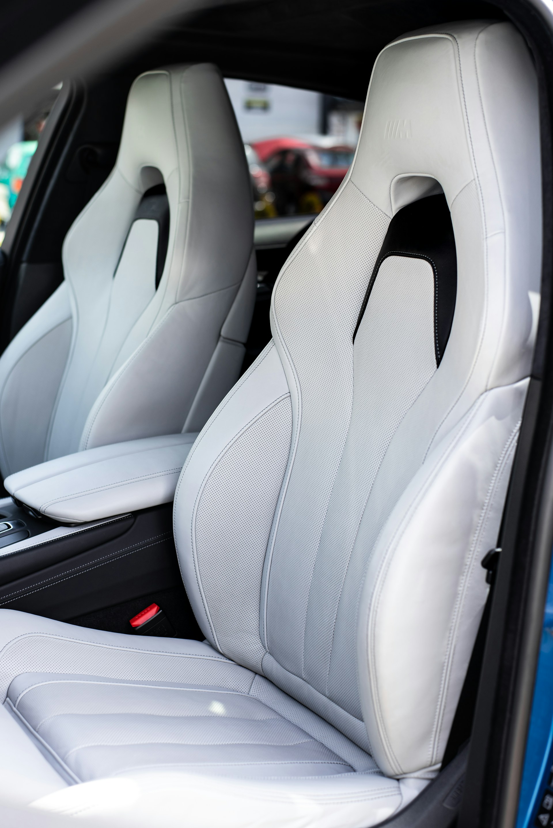 the interior of a car with white leather seats