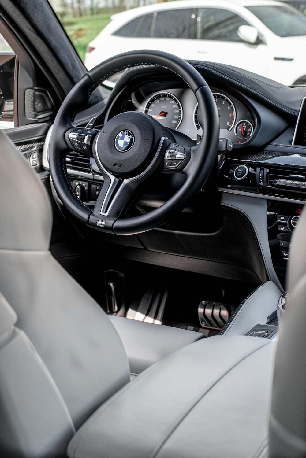 the interior of a car with a steering wheel and dashboard