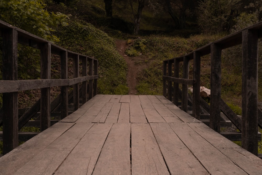 a wooden bridge with a bench on the side of it