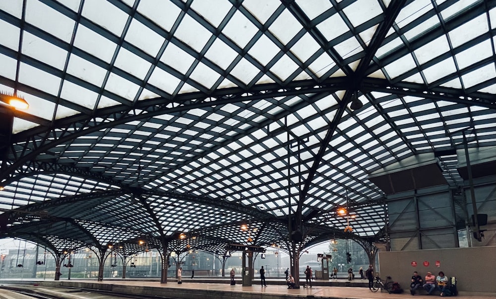 a train station with people waiting for the train