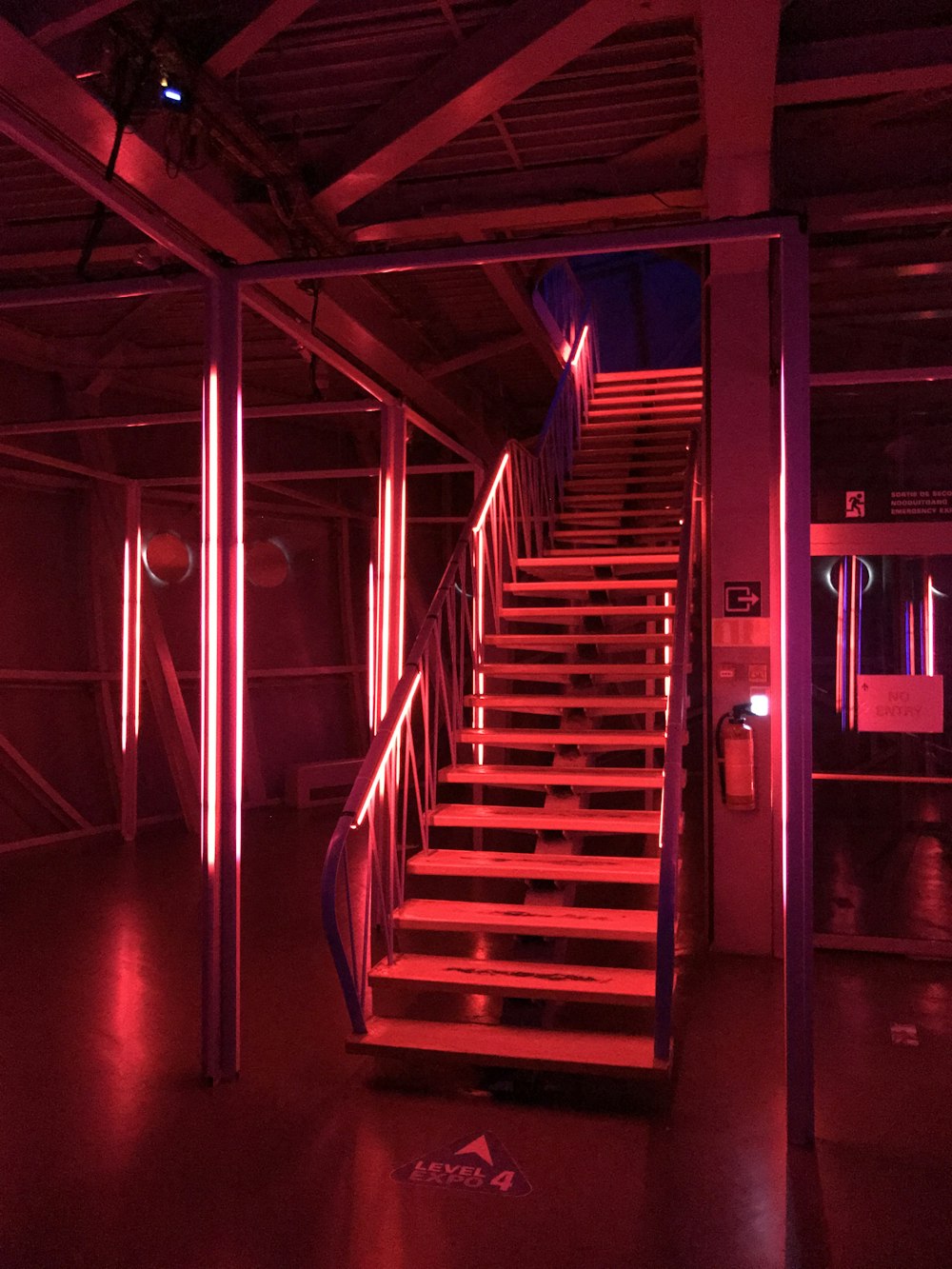 a set of stairs lit up with red lights