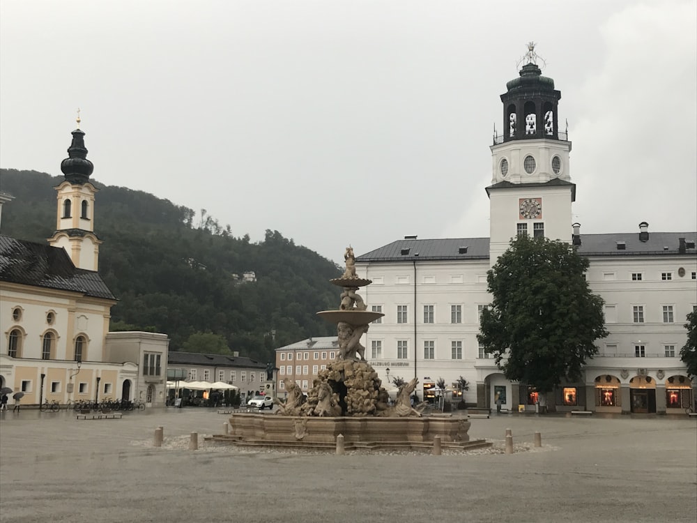 a large building with a fountain in front of it