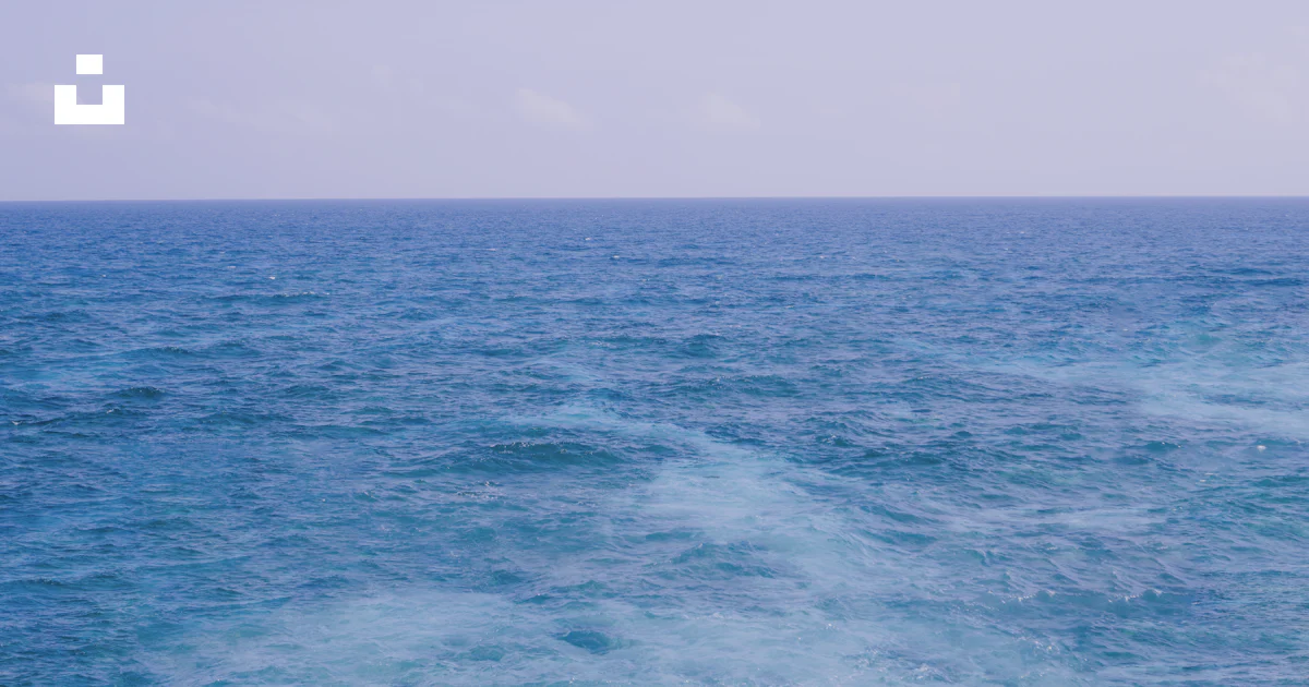 Ocean In The Distance A large body of water with a boat in the distance photo – Free Ocean ...