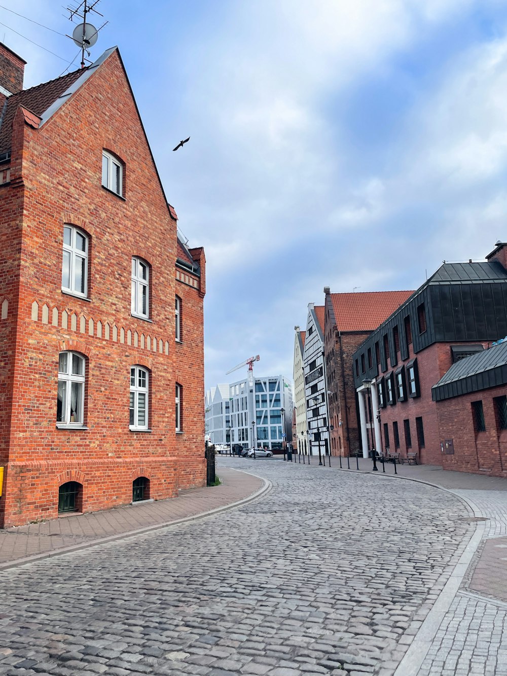 a cobblestone street lined with brick buildings