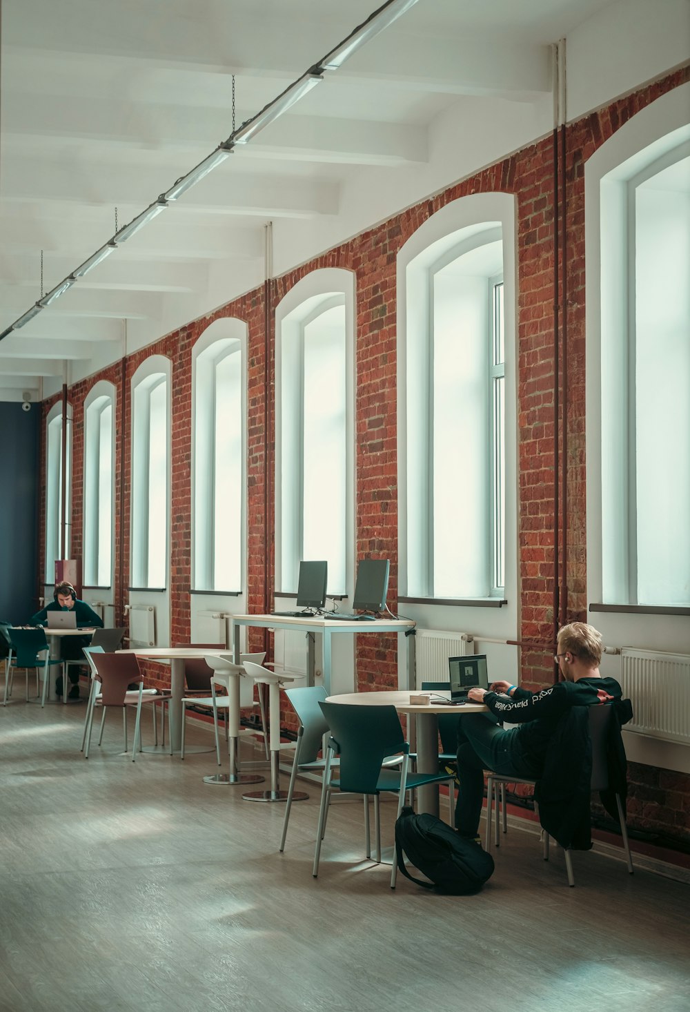 a person sitting at a table with a laptop