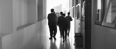 A team of lawyers walking purposefully through a marble hallway.