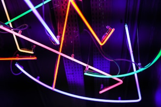 a bunch of neon lights hanging from a ceiling