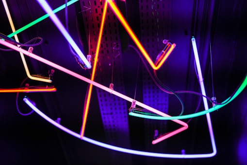 a bunch of neon lights hanging from a ceiling