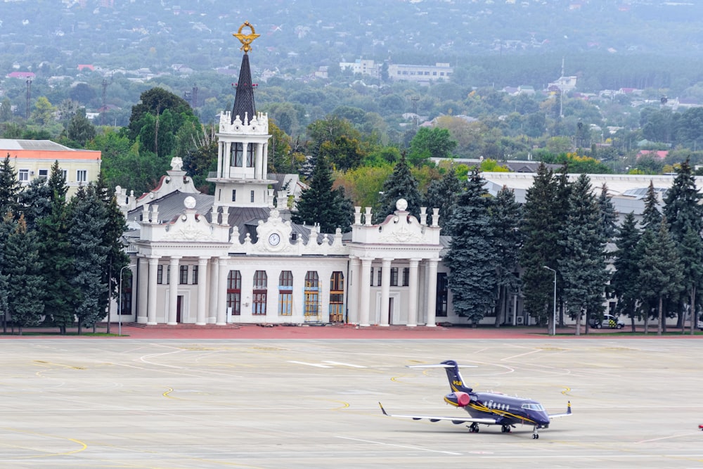 a small plane is parked in front of a building