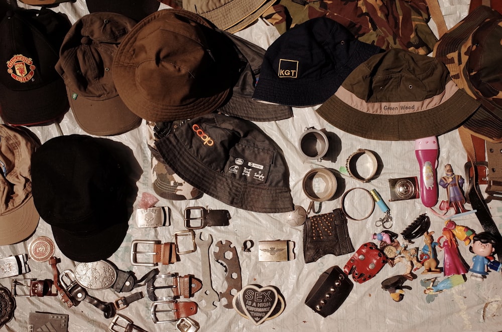 a table topped with lots of hats and other items