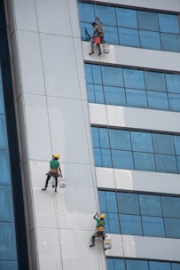 a group of people on the side of a tall building