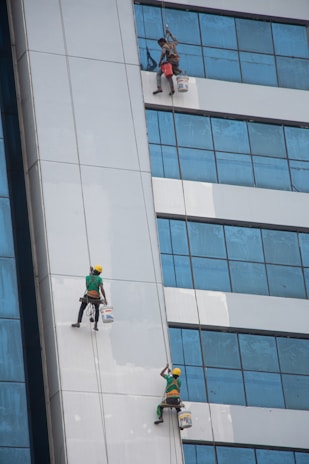 a group of people on the side of a tall building