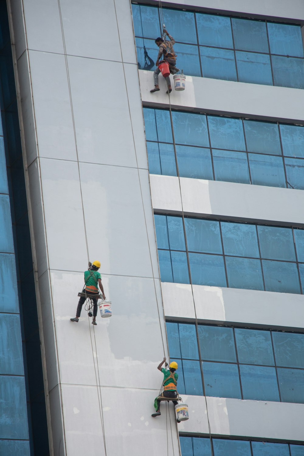 a group of people on the side of a tall building