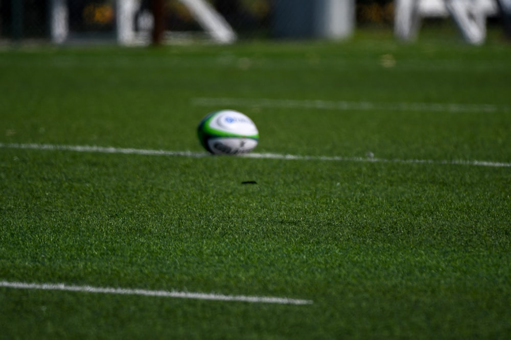 a soccer ball sitting on top of a green field