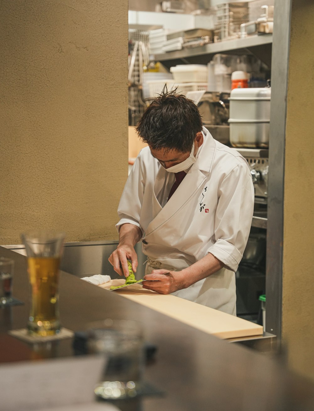 a man in a chef's uniform preparing food in a kitchen