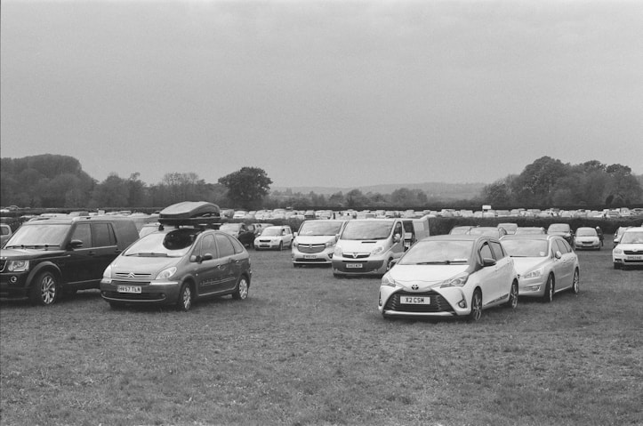 a group of cars parked in a field