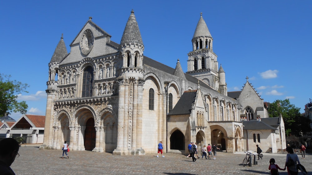 a group of people standing in front of a large building