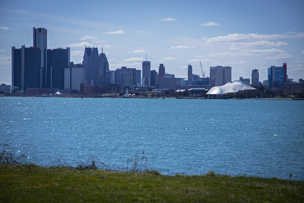 a large body of water with a city in the background