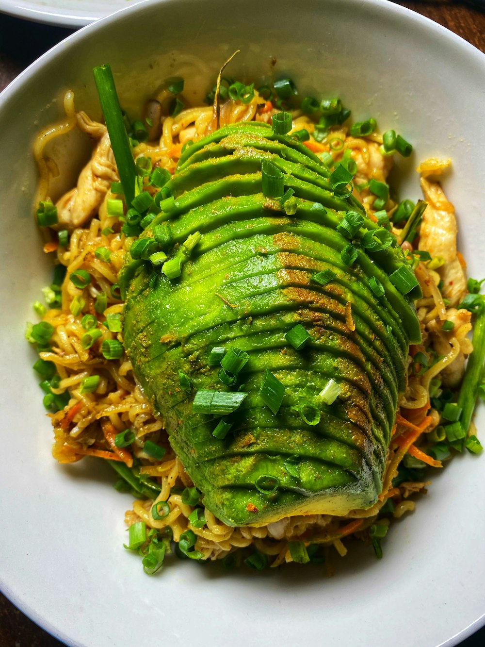 a white bowl filled with rice and vegetables