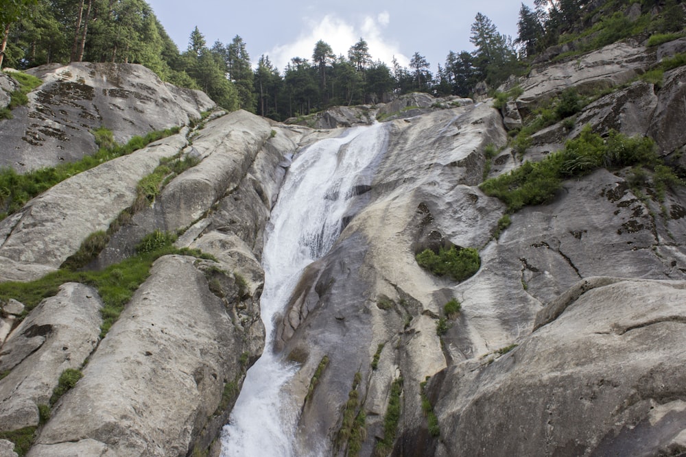 a waterfall in the middle of a rocky area