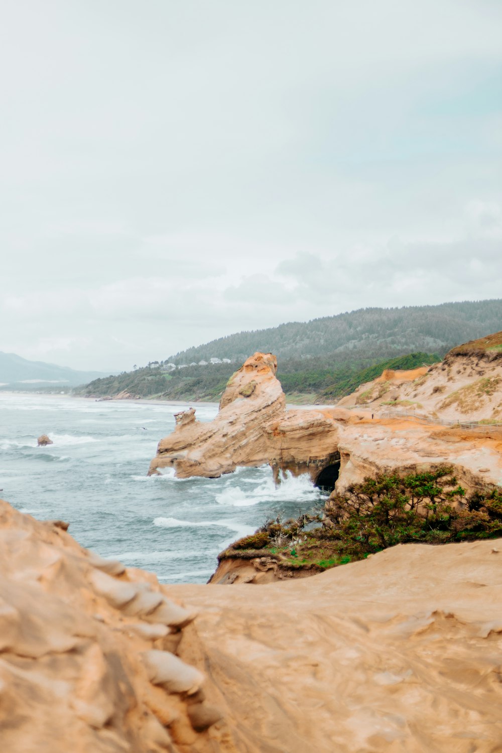 a person standing on a cliff overlooking the ocean