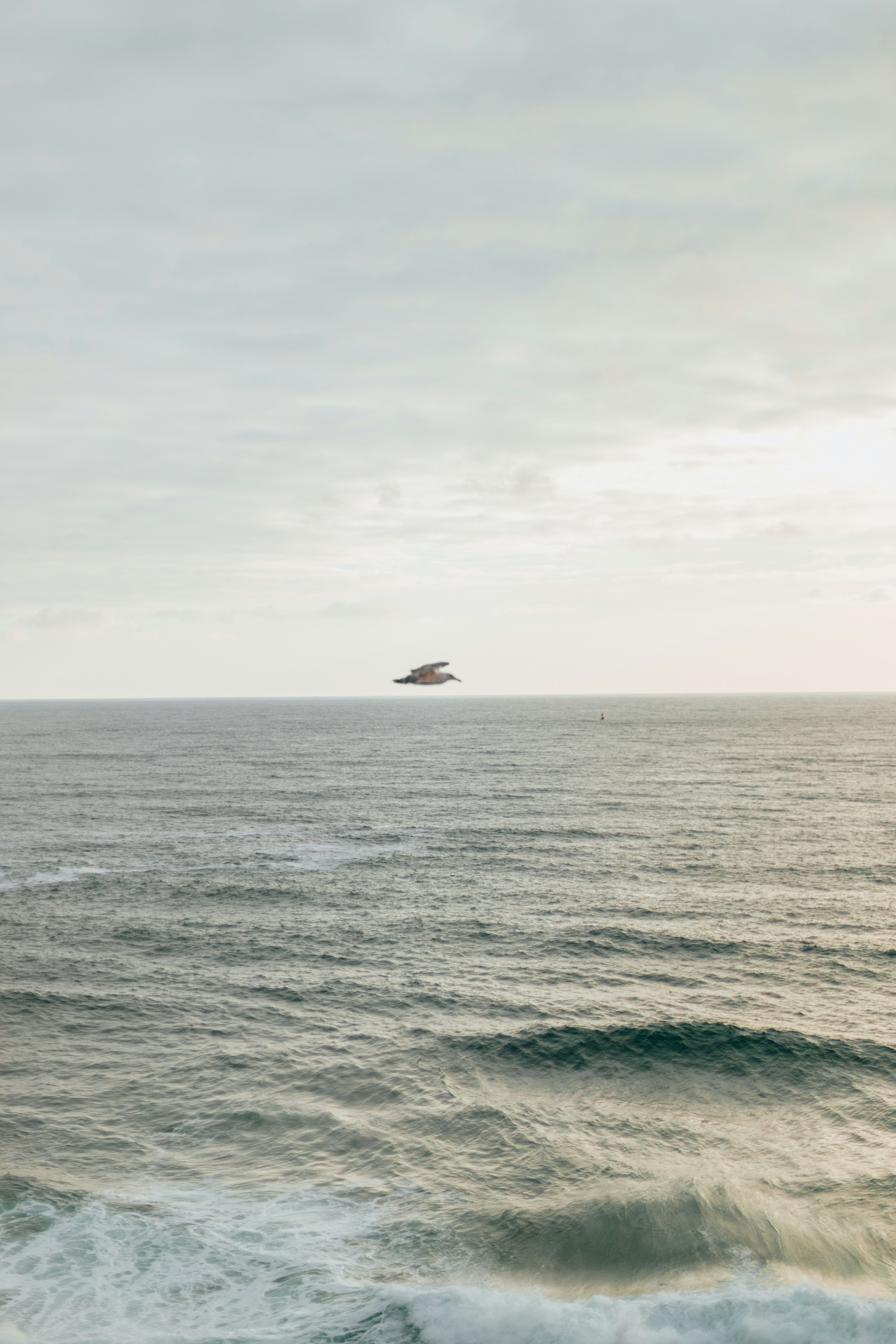a large body of water with a boat in the distance