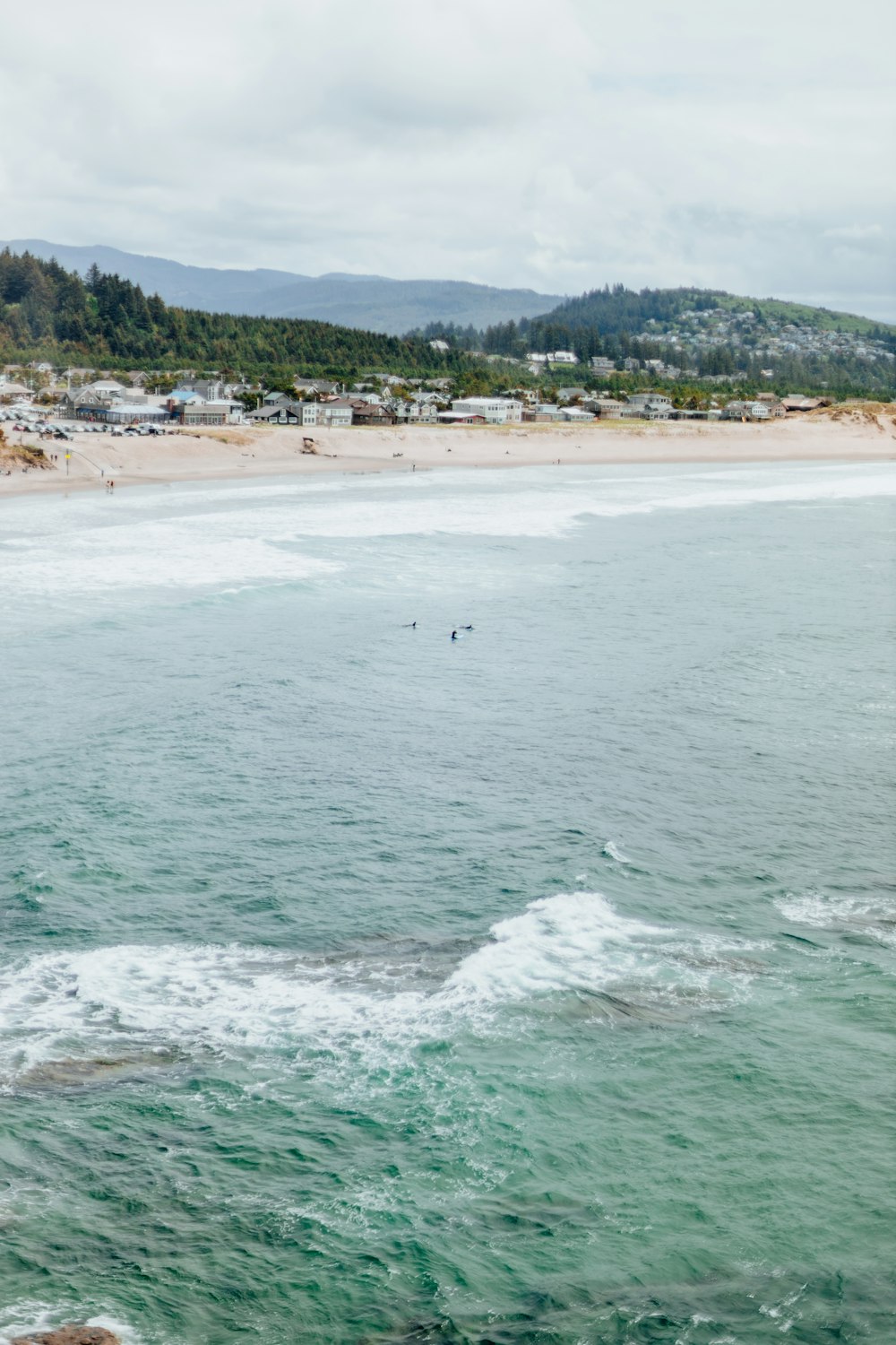 a person riding a surfboard on top of a wave in the ocean