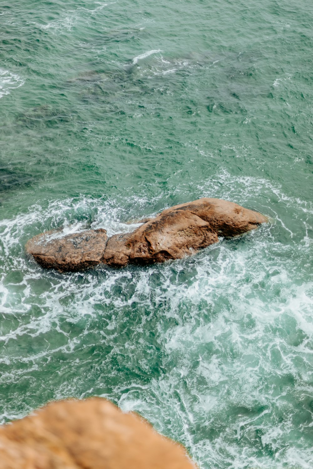 a rock in the middle of a body of water