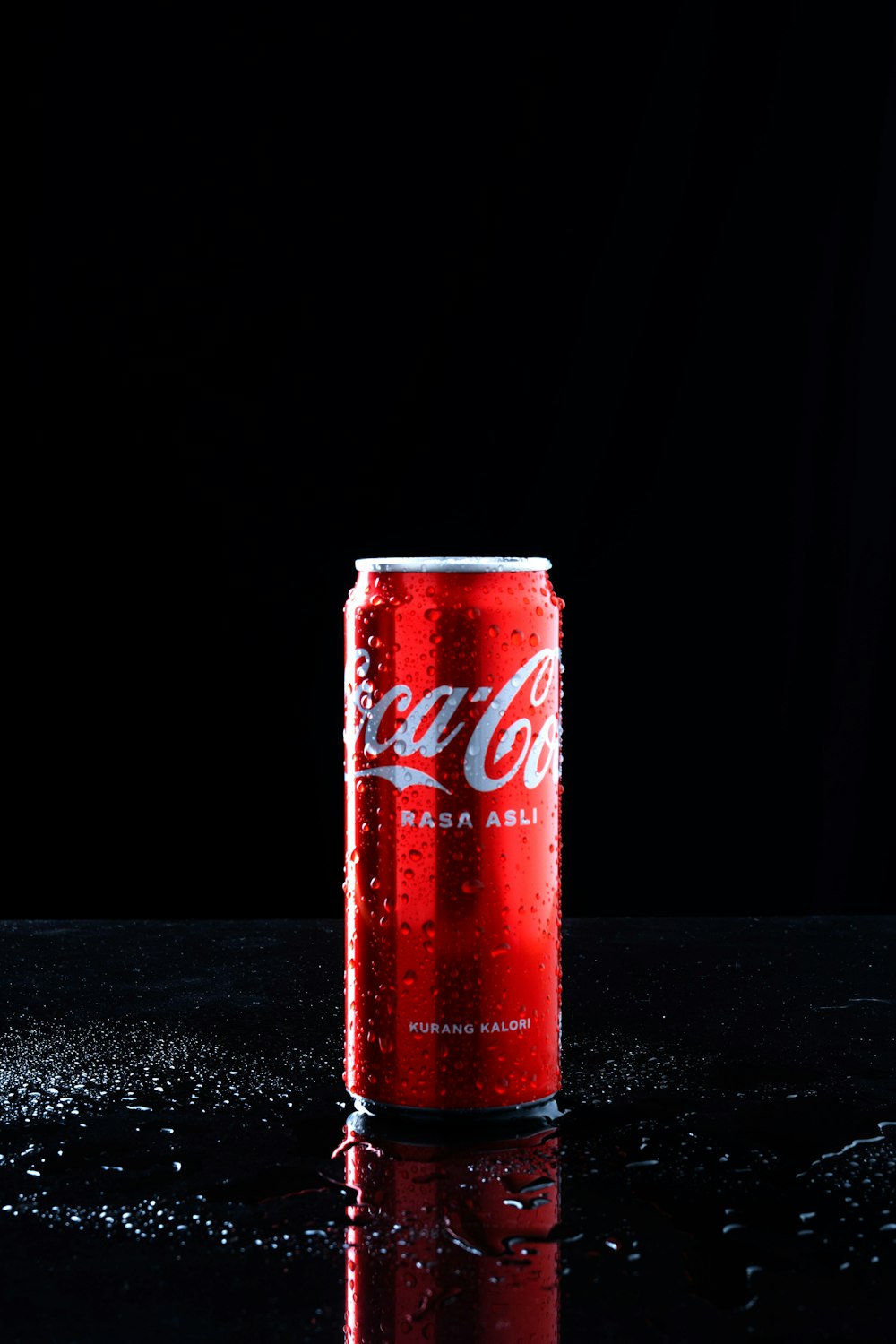 a can of coca cola sitting on top of a table