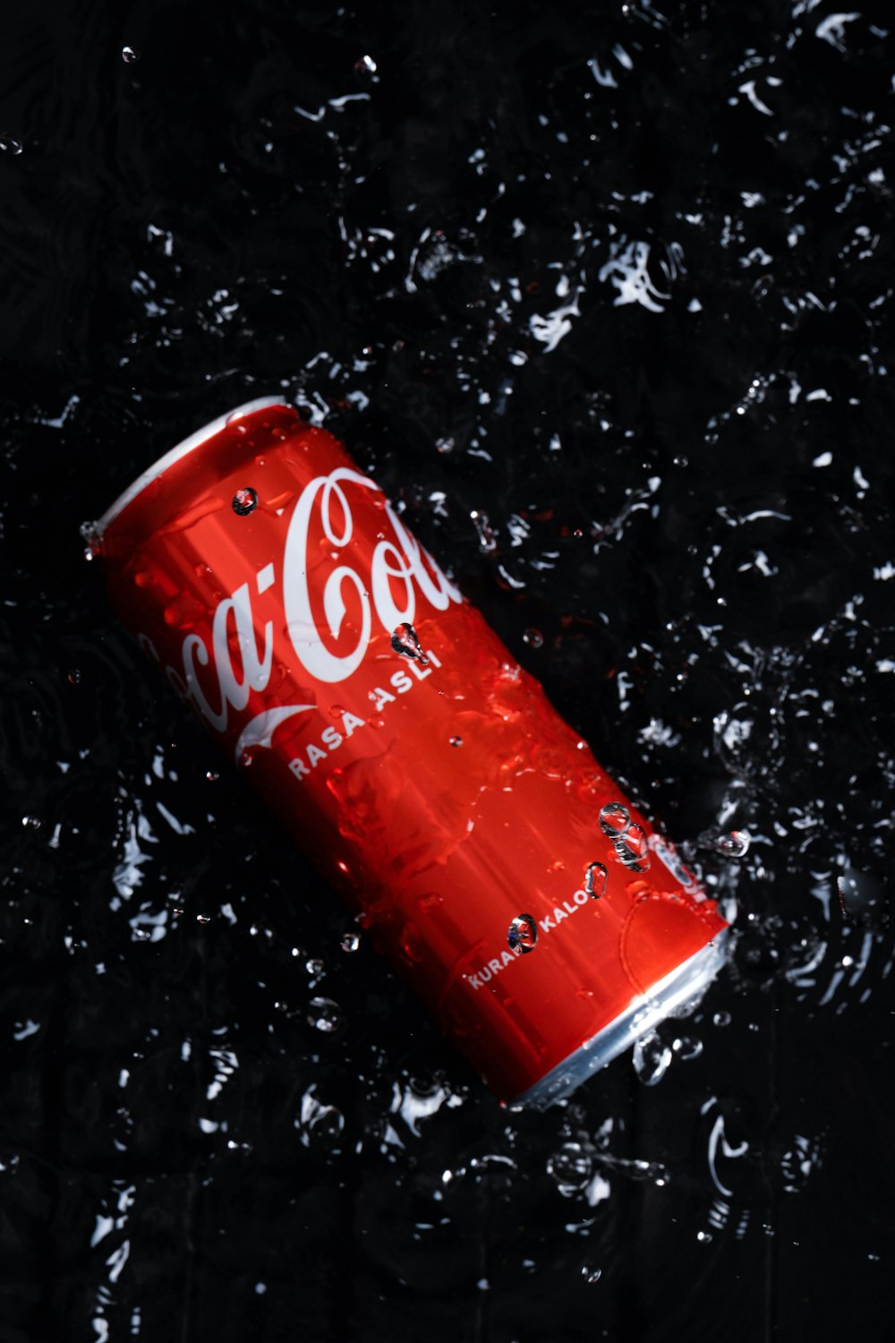 a can of coca - cola in the water