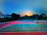 A freshly resurfaced backyard pickleball court glowing under soft evening light.
