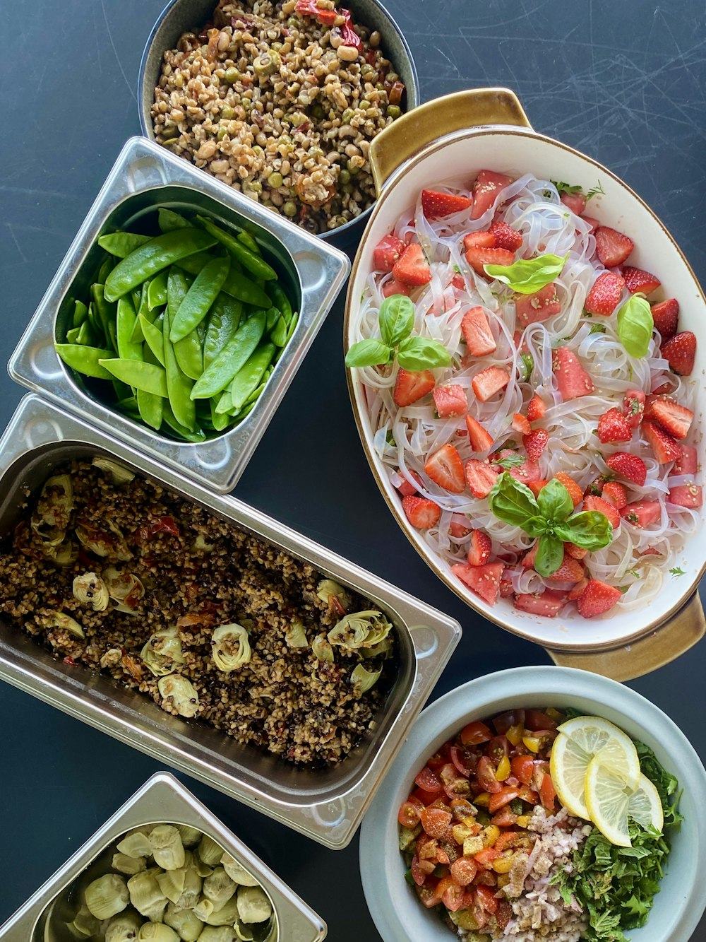 a table topped with bowls filled with different types of food