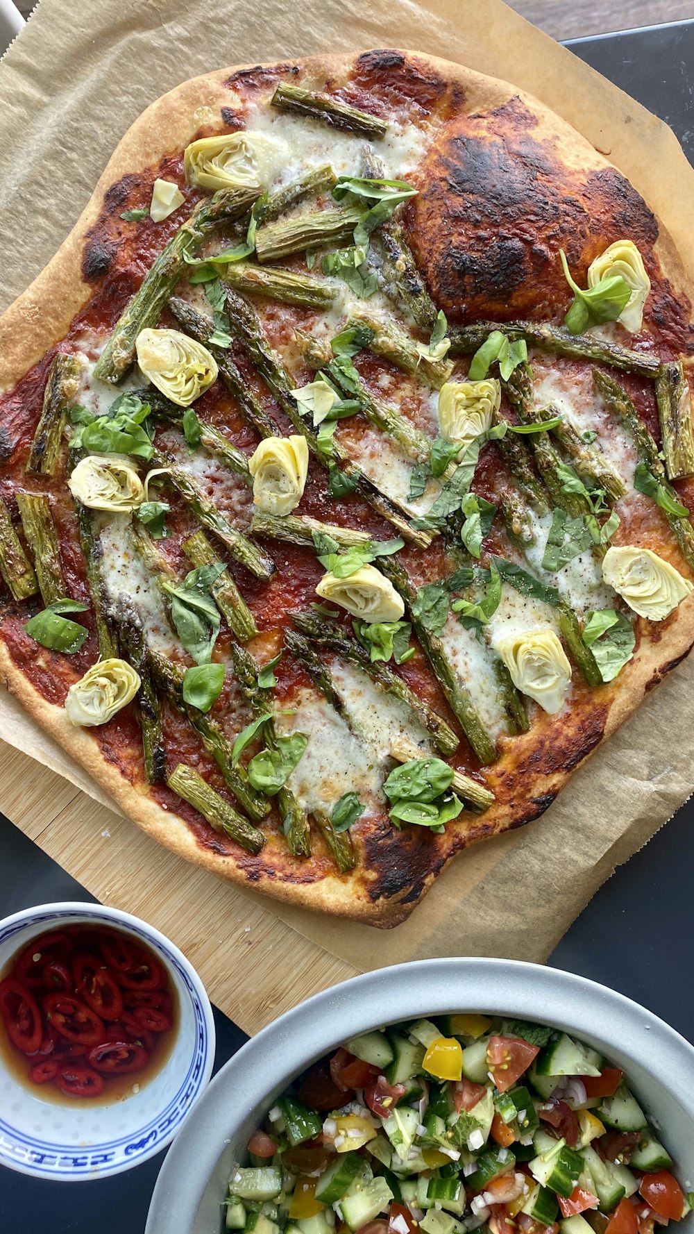 a pizza sitting on top of a wooden cutting board