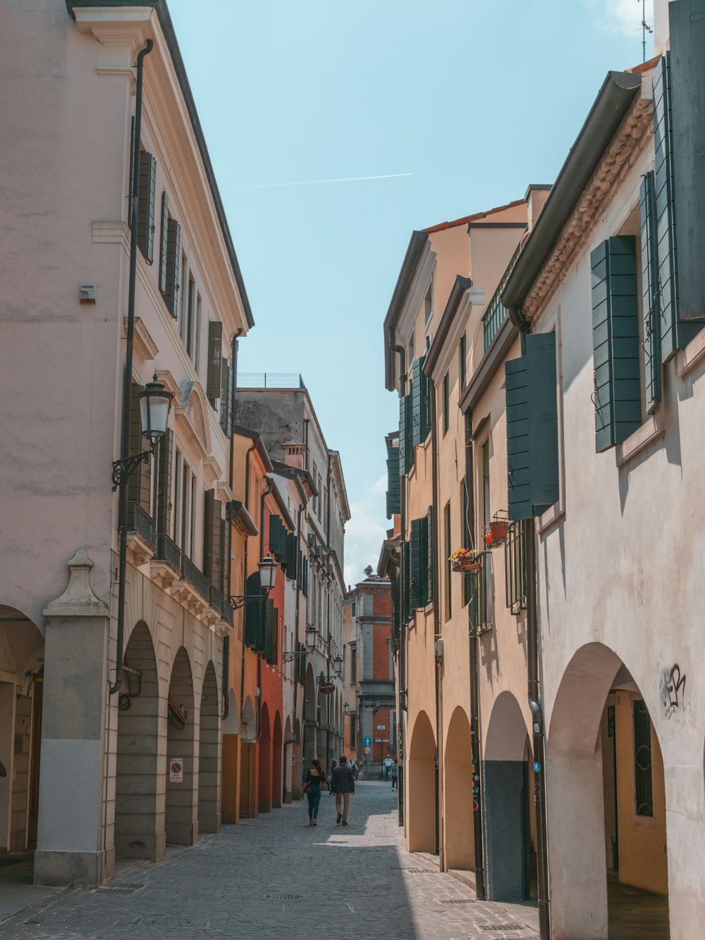 a narrow city street with buildings on the side of a building