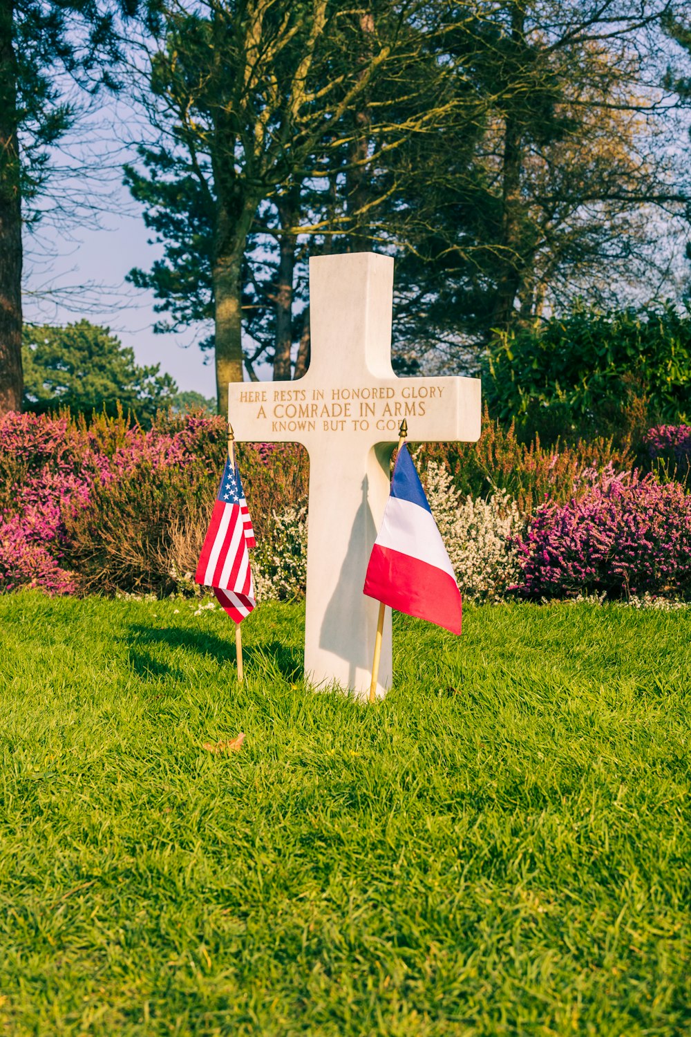 a white cross with an american flag on it