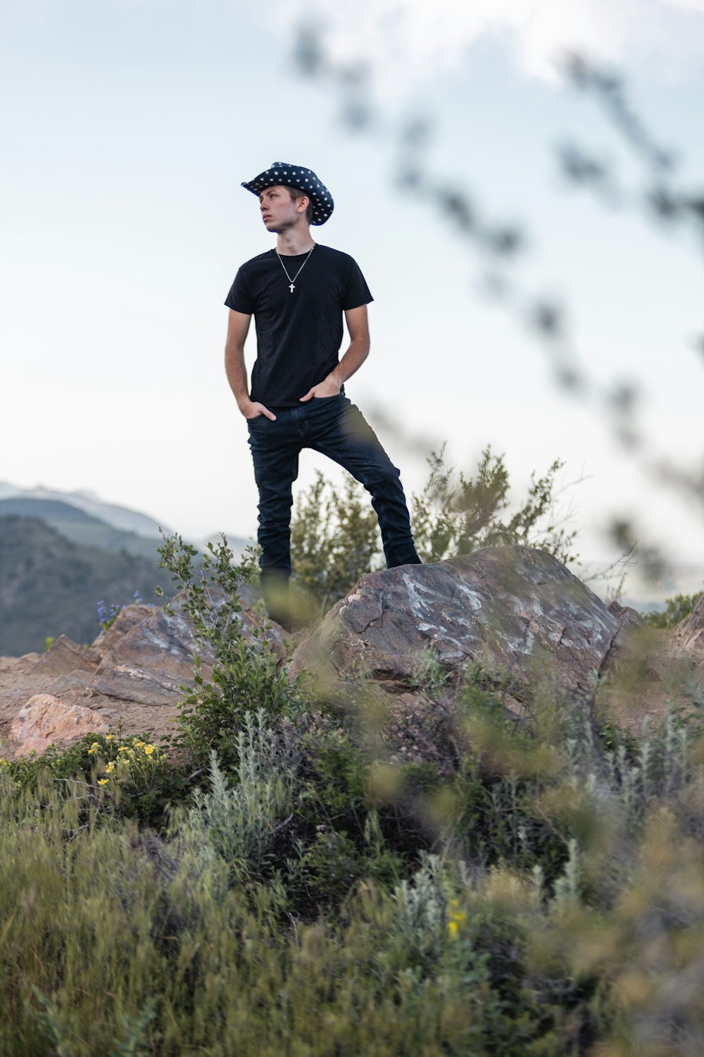 a man standing on top of a rock in a field