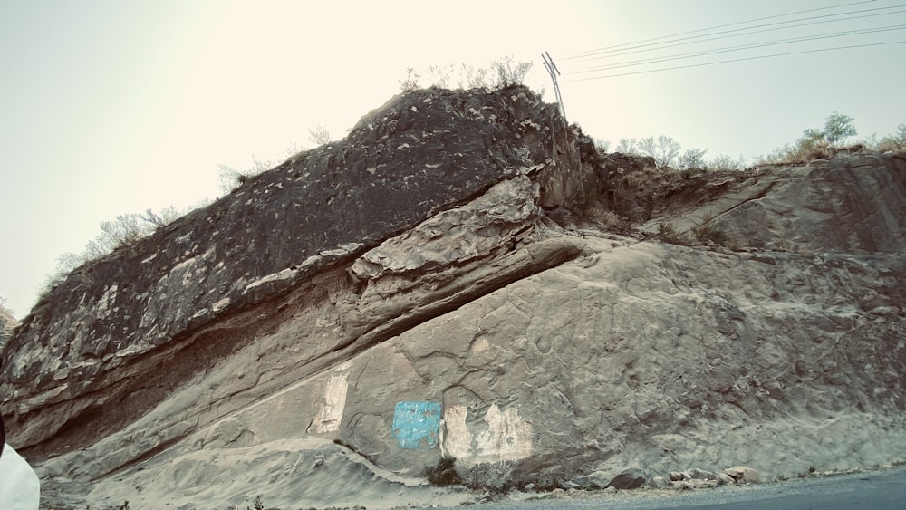 a large rock with graffiti on the side of it