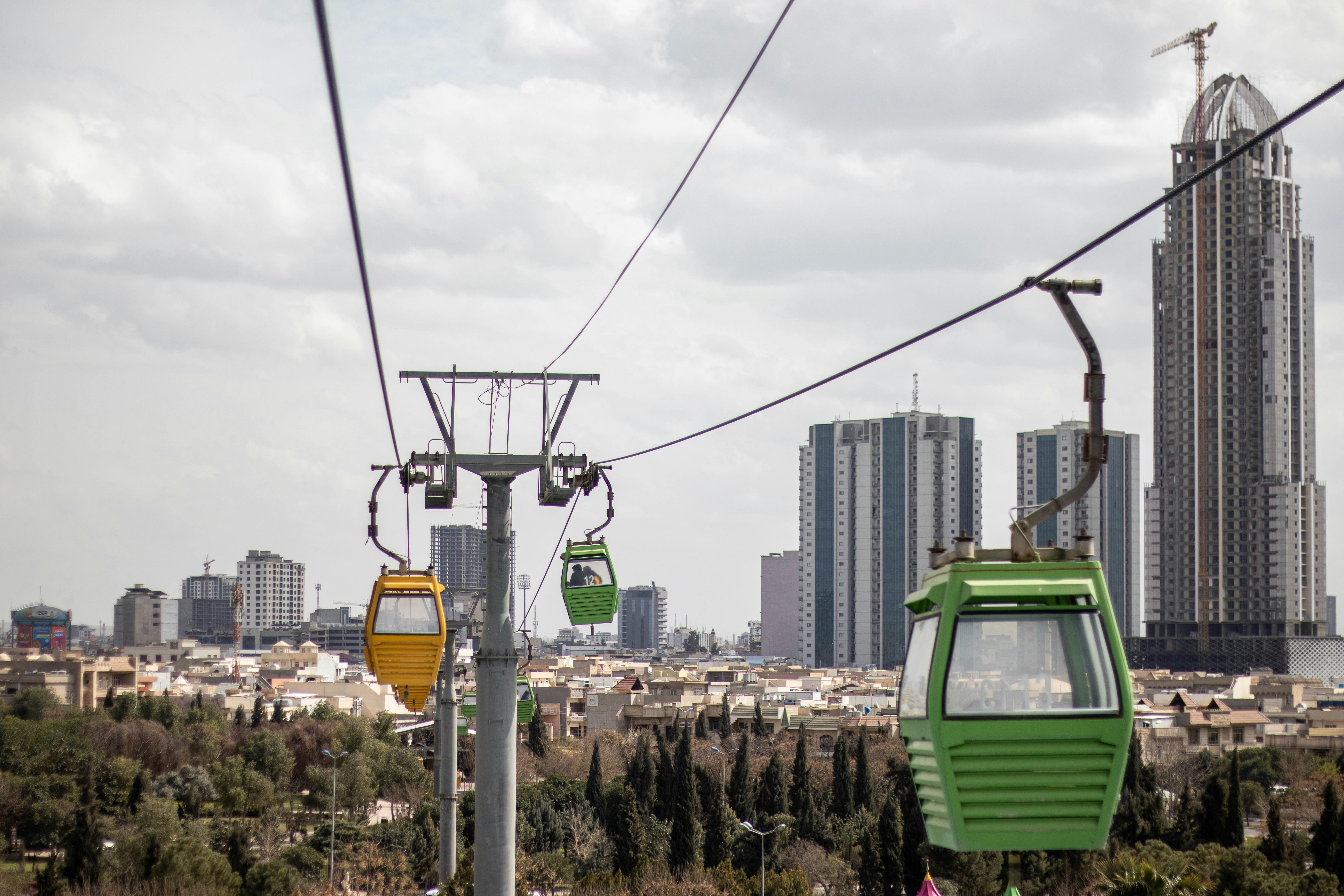 a green and yellow trolly car on a city street