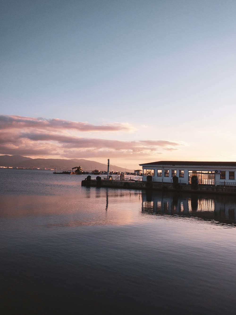 a boat is docked at the end of a pier