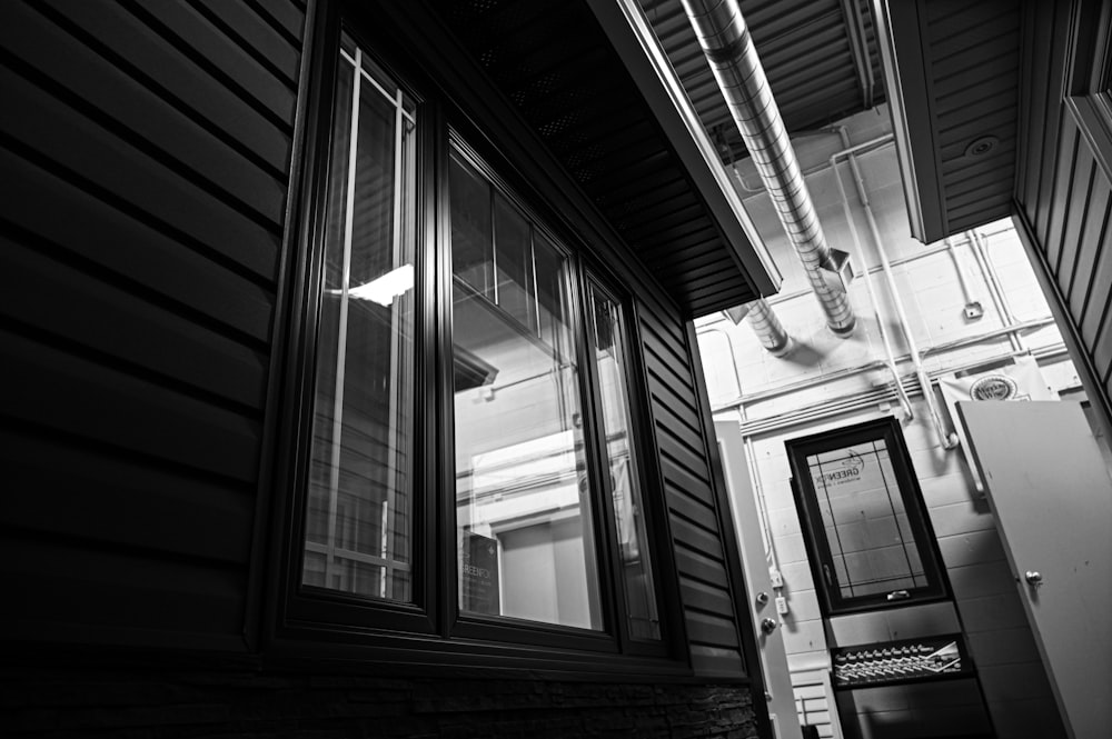 a black and white photo of a door and window