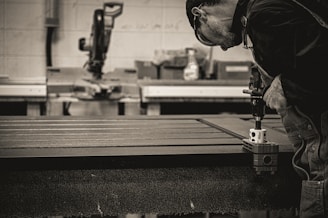 a man working on a machine in a factory