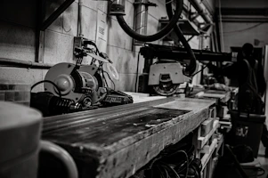 Workshop scene showing technicians repairing industrial machinery with tools and parts