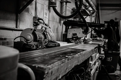 A futuristic workshop scene with glowing tools and robotic arms assembling parts.