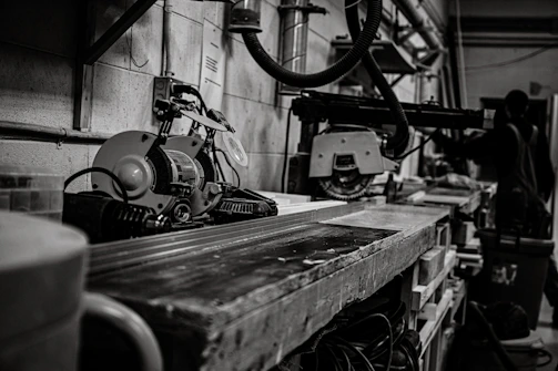 Workshop scene showing technicians repairing industrial machinery with tools and parts