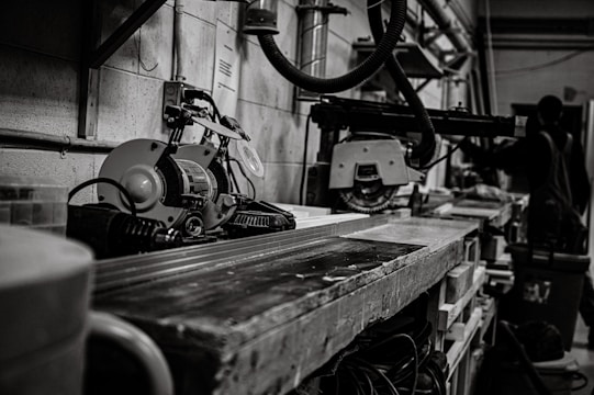 An industrial workspace featuring machinery and tools in action.