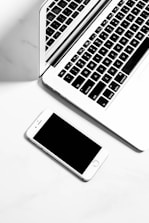 a laptop and a cell phone on a table